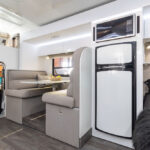 fridge abd dinette in the Avida Esperance C7834SL Motorhome